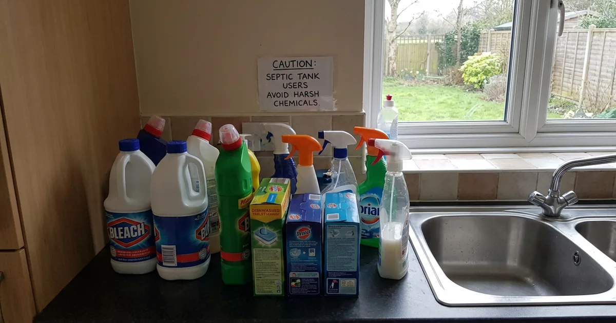 Household cleaning products and chemicals next to a kitchen sink in a UK home